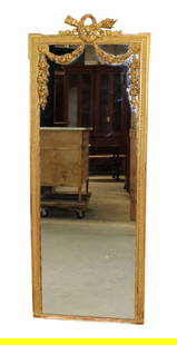 French Louis XVI style giltwood mirror with torch and quiver focal: French Louis XVI style giltwood mirror with torch and quiver focal. Overall size 63"h x 24"w