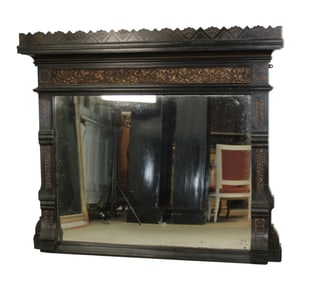 Arts & Crafts ebonized mirror with relief foliate decoration