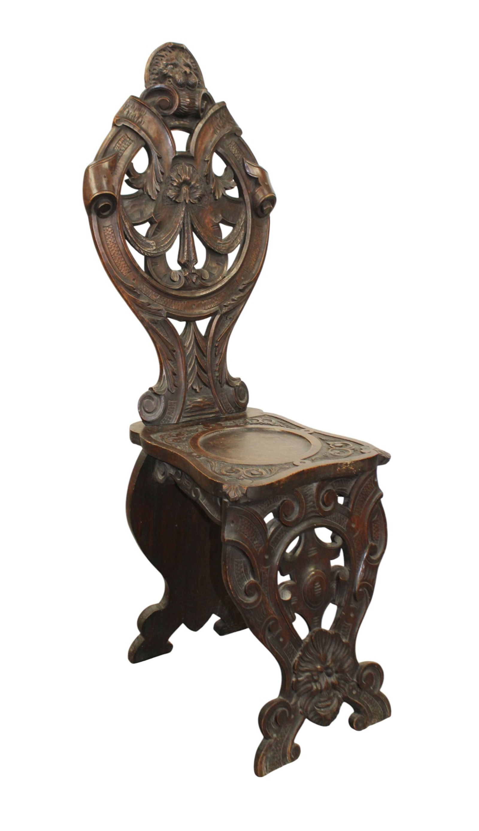Italian relief carved hall chair in walnut: Italian relief carved hall chair in walnut. Early 20th century. 46"h x 13 1/2"w x 17"d. Seat height 19"