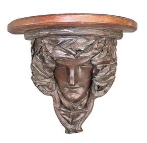 Relief carved oak wall shelf with mask