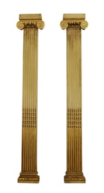 Pair of painted and parcel gilt fluted pilasters with Ionic capitals