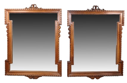 Companion pair of French carved mirrors with ribbon crest