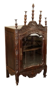 French Provincial verrio cabinet in carved walnut with glass door and spires
