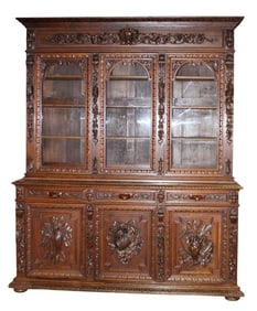 French Louis XIII 3 door bookcase in oak with Bacchus head and attributes of hunt and harvest