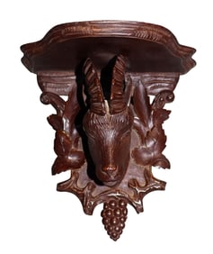 Black Forest relief carved walnut wall shelf with antelope