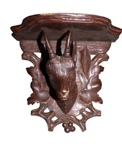 Black Forest relief carved walnut wall shelf with antelope