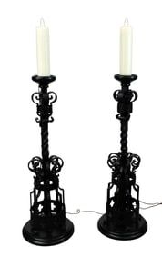 Pair of gothic style iron torchiere floor lamps with wax candle sleeves