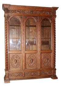 French 3 door bookcase in oak with carved lion heads and barley twist columns