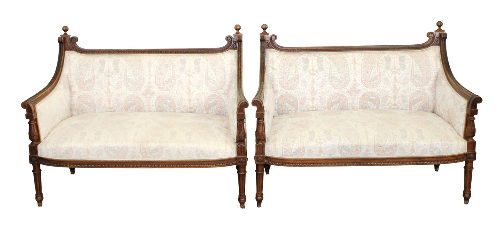 Pair of French Louis XVI style settees in carved walnut: Pair of French Louis XVI style settees in carved walnut with ball finials. Early 20th century 34"h x 44"w x 191/2"d Seat 15"h