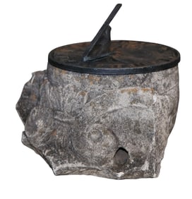 Architectural stone fragment with bronze sundial