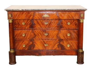 French Empire commode in flame mahogany with columns and a marble top