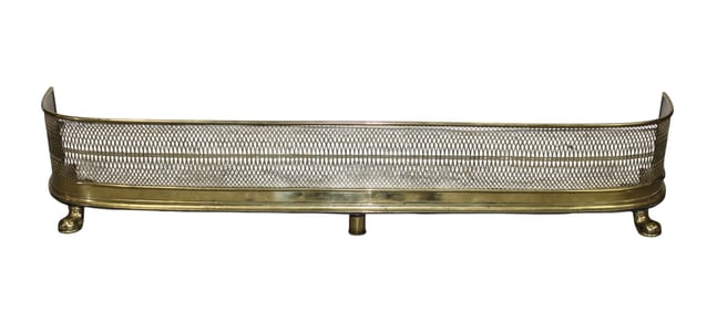 English curved side pierced brass fire fender on paw feet