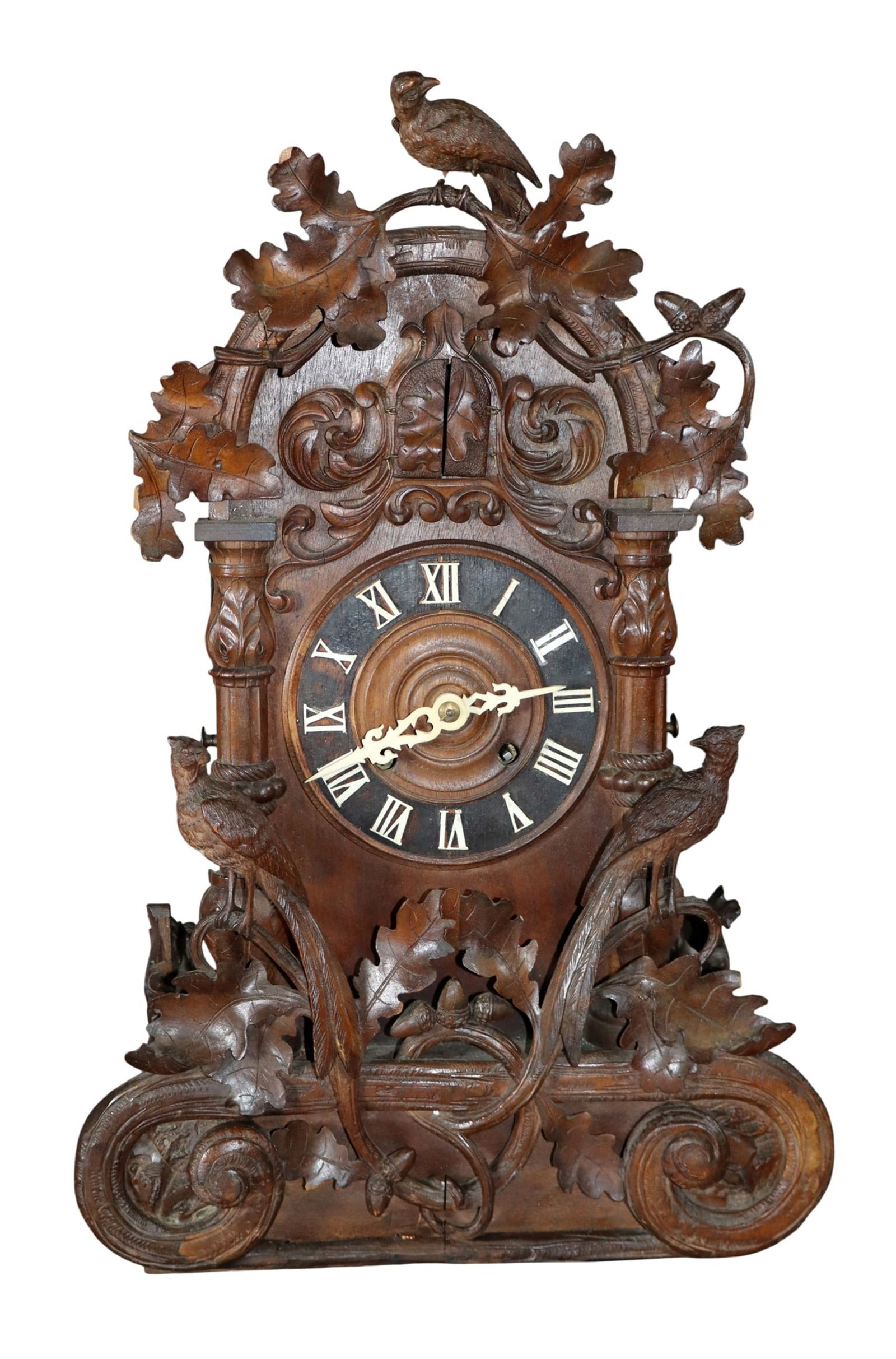 Swiss Black Forest carved walnut cuckoo clock: Swiss Black Forest carved walnut cuckoo clock with oak and ivy leaves. Late 19th century. 19 1/2"h x 13"w x 6 1/4"d. Weight: 8lbs