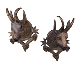 Pair of Black Forest carved antelope trophy plaques with glass eyes