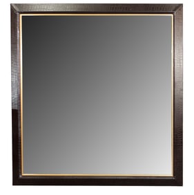 Embossed leather framed mirror with beveled glass.