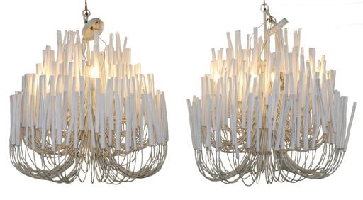 Pair of Arteriors Tilda chandeliers with painted wood on pliable iron arms.