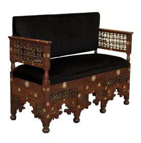 Moorish heavily carved settee with inlays and upholstered seat & back