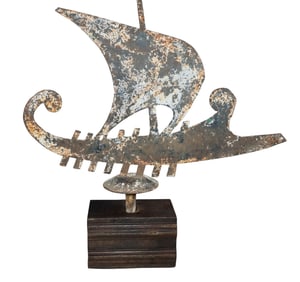 Verdigris iron roof finial of ancient Greek Athenian trireme ship mounted on wooden stand
