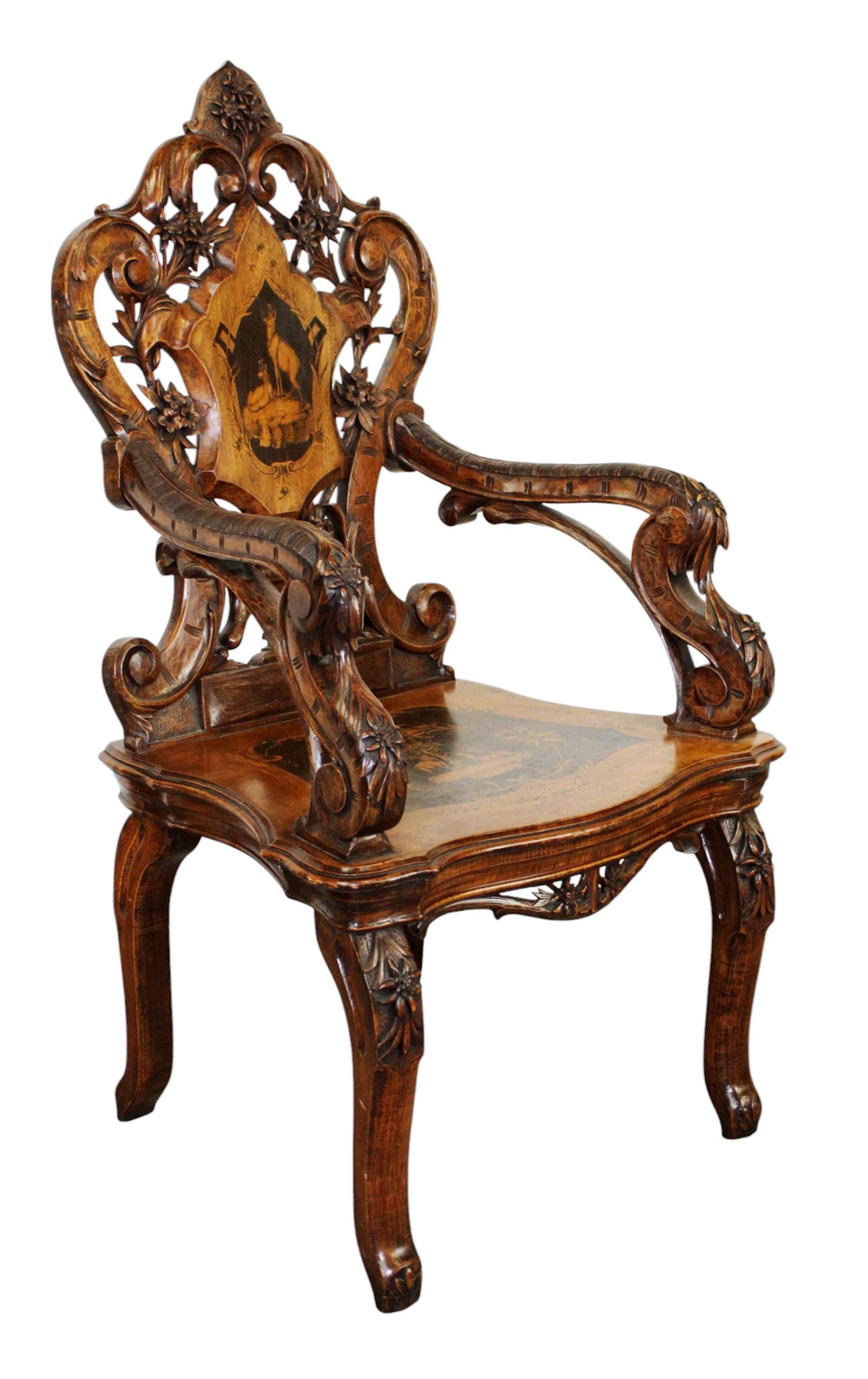 Swiss Black Forest carved walnut musical armchair with inlaid antelopes: Swiss Black Forest musical chair with inlaid elk and carved edelweiss. Late 19th century. 47 3/4"h x 26 3/4"w x 22 5/8"d, seat height 18 3/4"