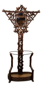 Black Forest pierce carved walnut hall tree with naturalistic carvings and center mirror