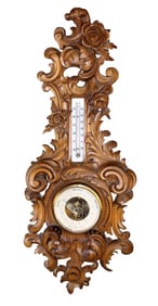 French carved walnut barometer with floral carvings