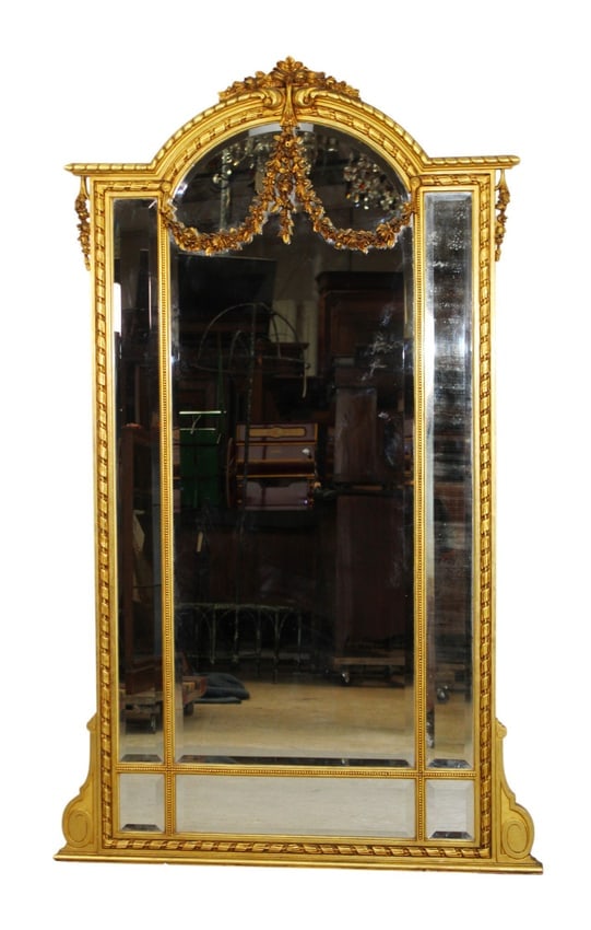 French Louis XVI style gilt mirror with floral garland: French Louis XVI style gilt mirror with floral garland and beveled glass. Early 20th century. 72"h x 44 1/2"w