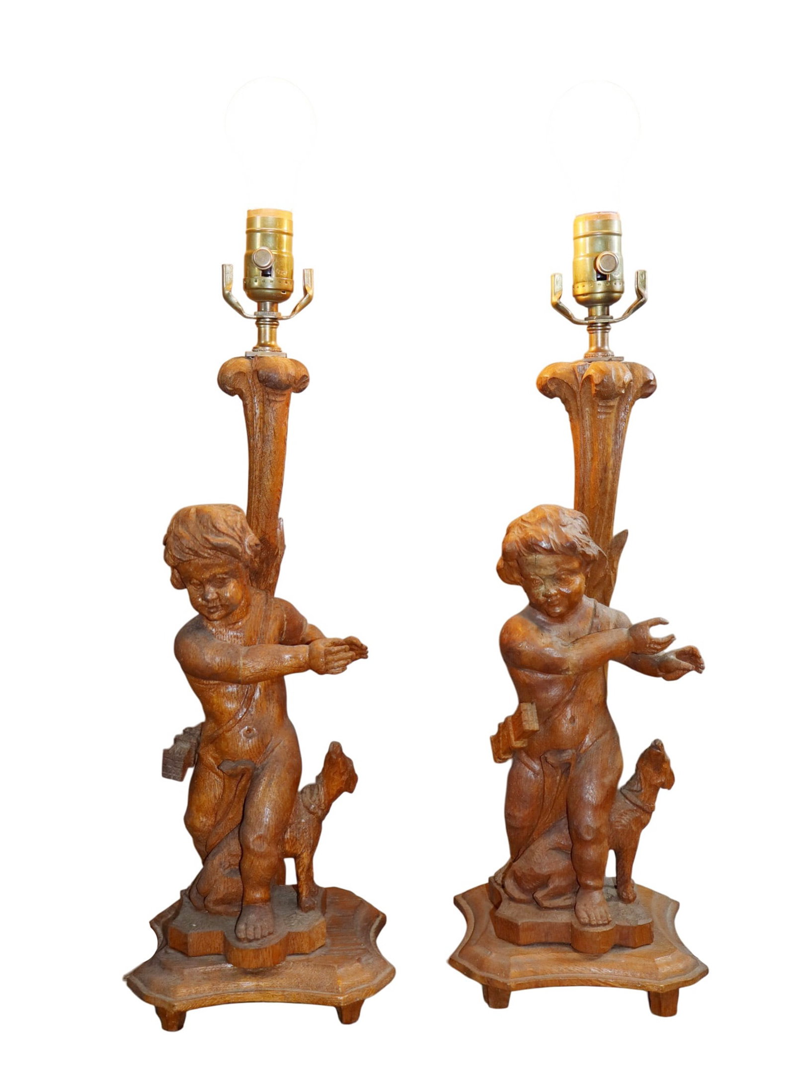 Pair of Italian figural carved oak cherubs mounted as lamps: Pair of Italian figural carved oak cherubs mounted as lamps. Early 20th century. Overall height. 22 1/2"h 6lbs