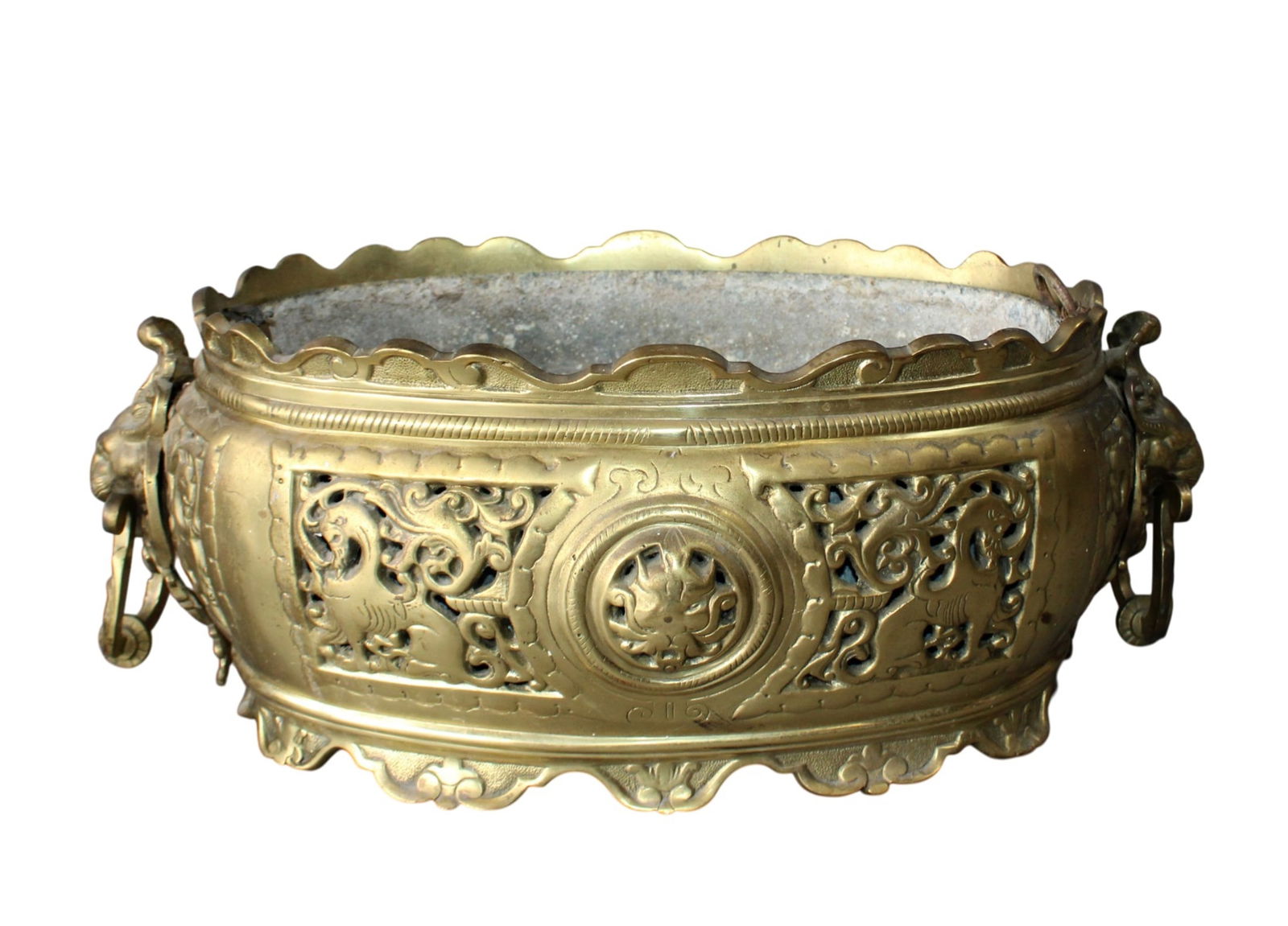 French jardiniere in pierced bronze with lion head handles: French jardiniere in pierced bronze with lion head handles. 6 1/2"h x 17 1/4"w x 8 1/2"d. Weight: 13lbs