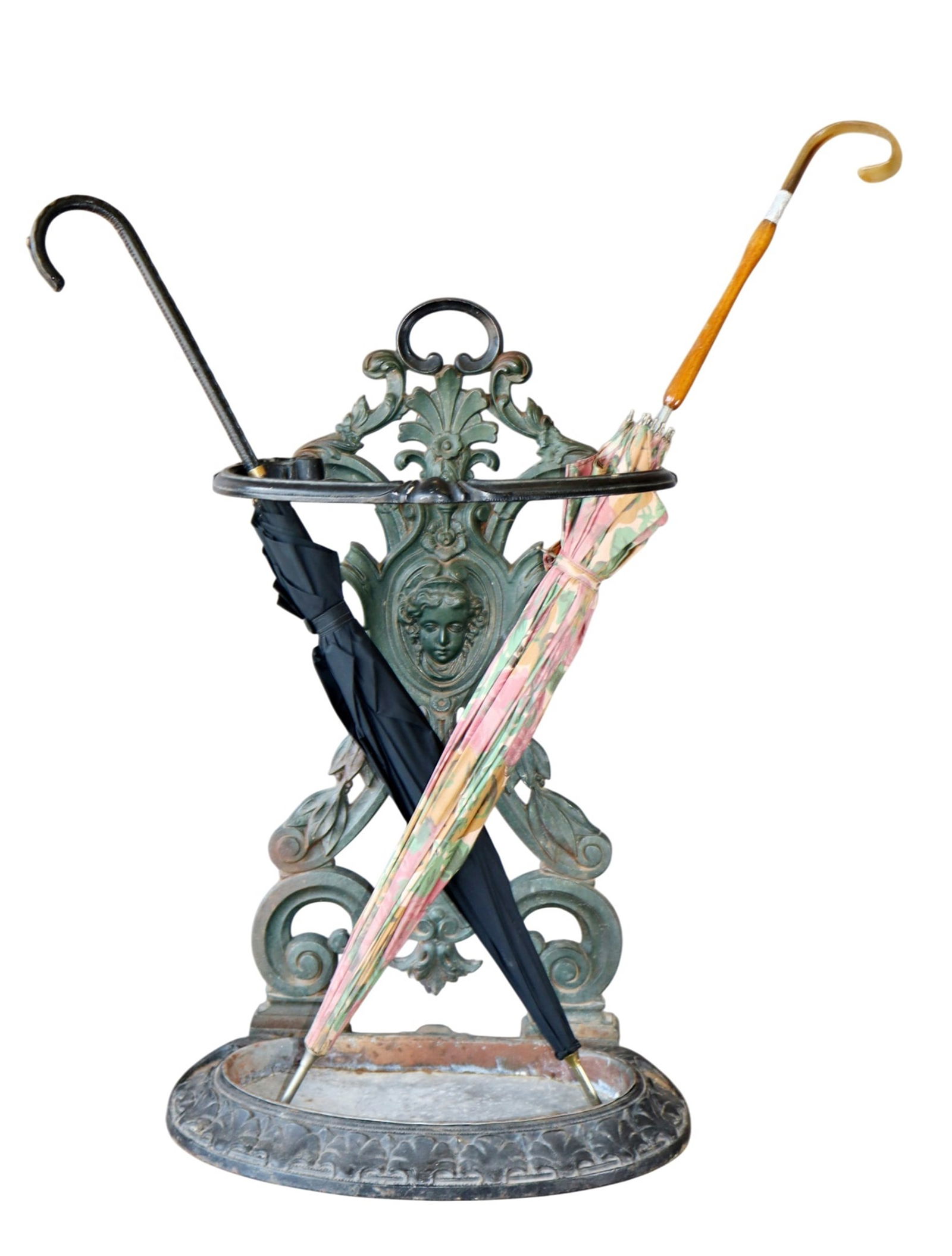 French enamel over iron umbrella stand with female mask: French enamel over iron umbrella stand with female mask. Early 20th century. . 24"h x 16 1/4"w x 10"d. Weight: 12lbs