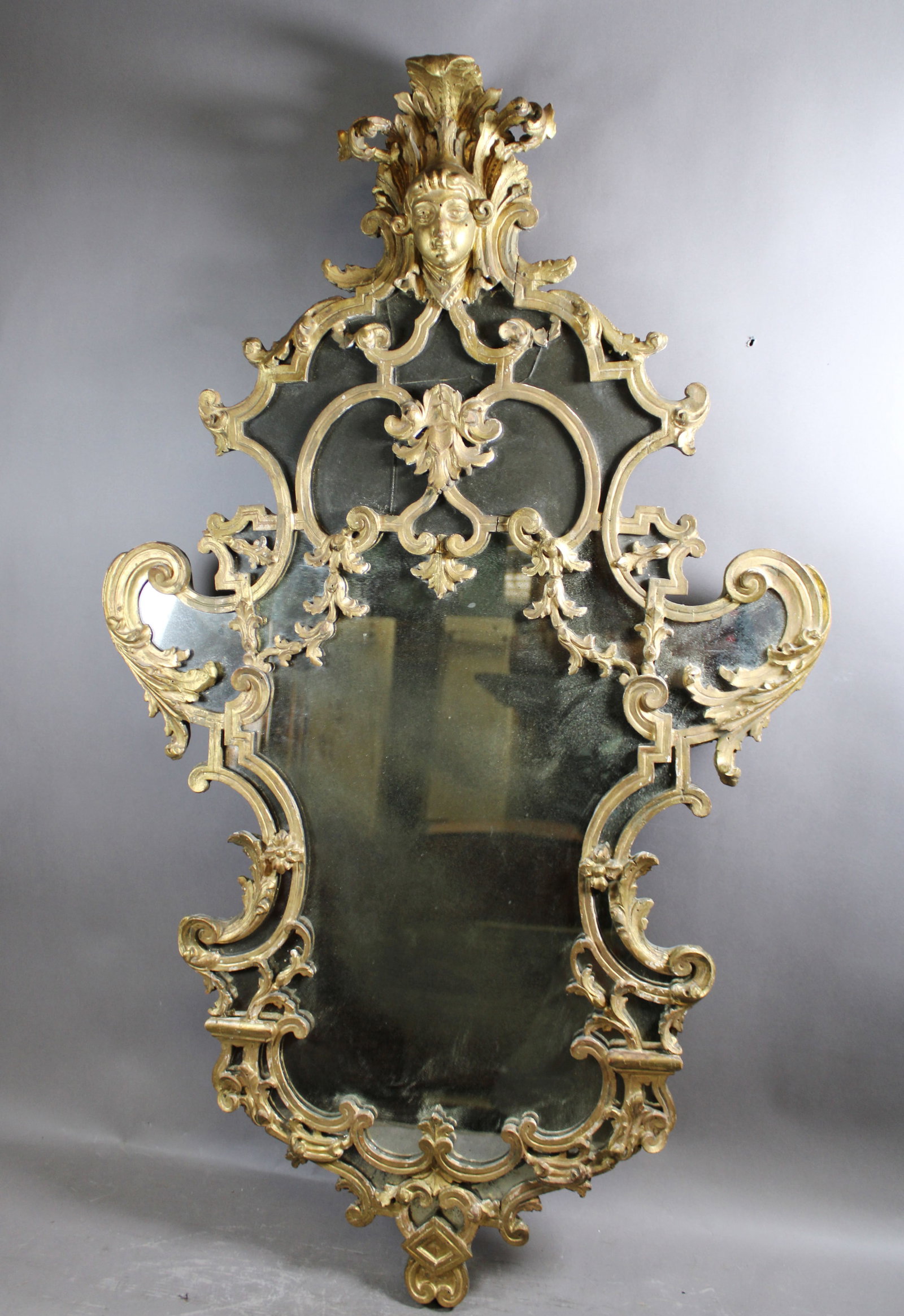 Italian Venetian carved wooden mirror with figural mask: Italian Venetian carved wood mirror with figural mask. 19th century. 42"h x 25"W x 5"d. Weight: 14lbs