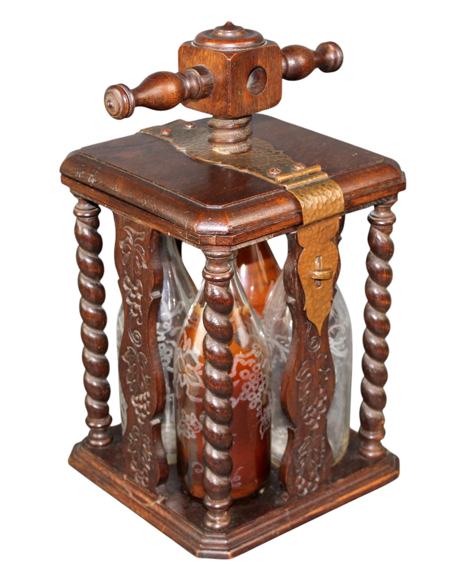 French carved wood & copper liqueur cabinet: French carved wood & copper liqueur cabinet with barley twist columns and 4 bottles. Mid 20th century. Overall: 16 1/2"h x 10"w x 9 1/8"d. Bottles: 9 1/4"h x 3 1/4"diam (each, approx.). Total weight: 