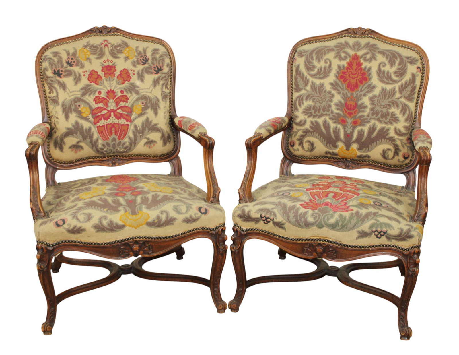 Pair of French Louis XV style armchairs in carved walnut with needlepoint upholstery: Pair of French Louis XV style armchairs in carved walnut with needlepoint upholstery. Each: 38 3/8"h x 26 1/2"w x 27"d, seat: 17 7/8"h