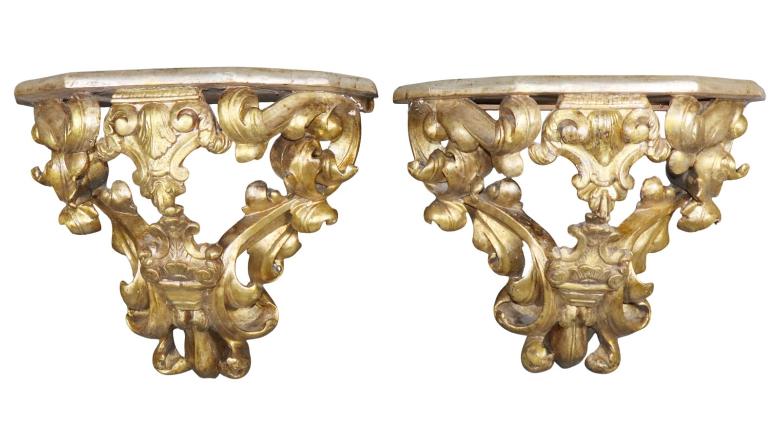 Pair of Italian carved and gilt wood wall shelves: Pair of Italian Rococo carved and gilt wood wall shelves with faux marble painted tops. Early 20th century. 16 1/2"h x 19 3/4"w x 10"d. Weight: 6lbs each