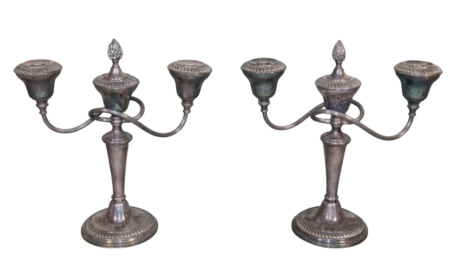 Pair of English silverplate candelabra marked E.P.O.C England: Pair of English silverplate candelabra marked E.P.O.C England. 12"h x 12 1/4"w Weight: 4lbs total