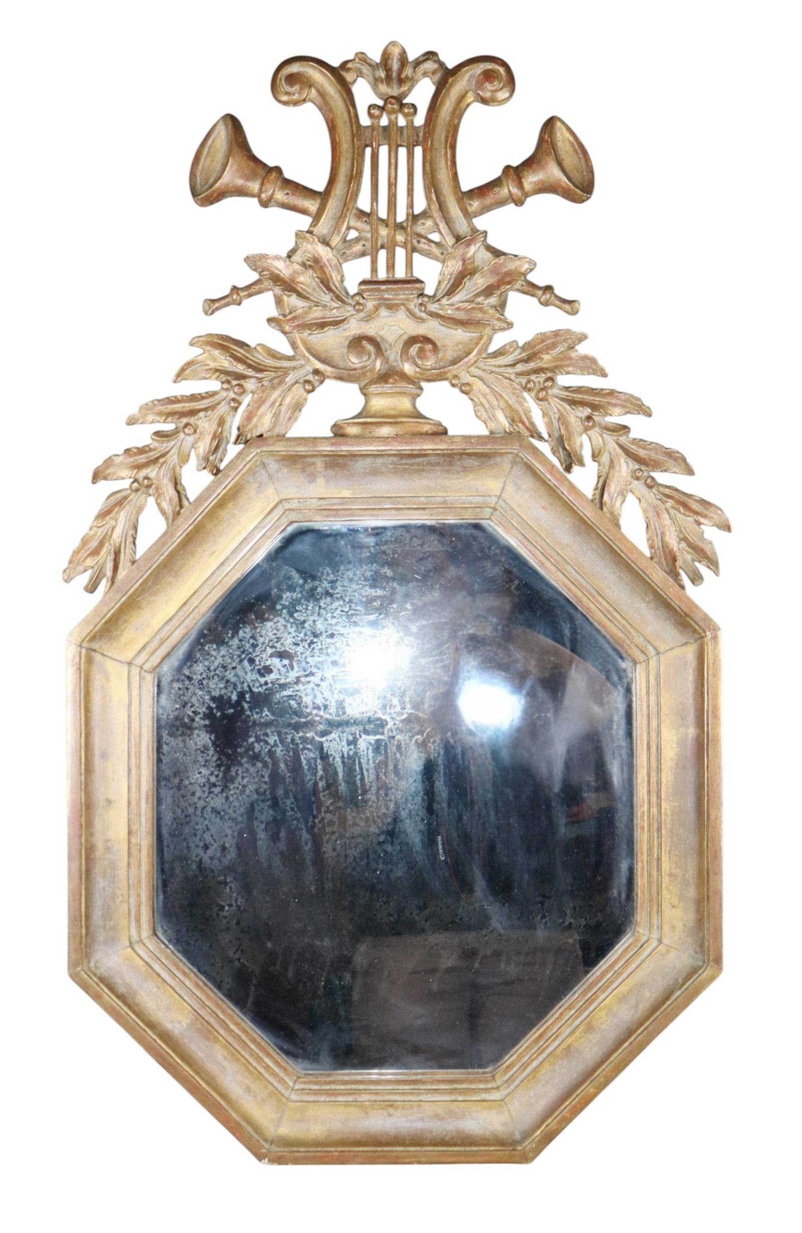 French Louis XVI gilt mirror with musical crest: French Louis XVI octagonal gilt mirror with musical crest. Early 20th century. 33"h x 19 1/2"w. Weight: 11lbs