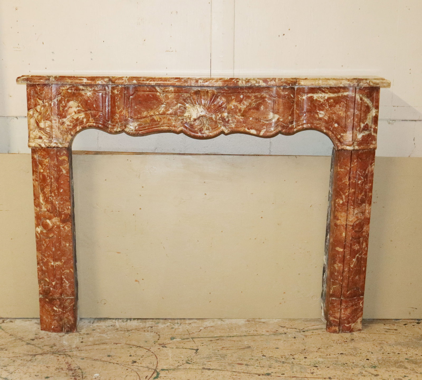 French Louis XV carved rouge marble mantel: French Louis XV carved rouge marble mantel. Late 19th century.
