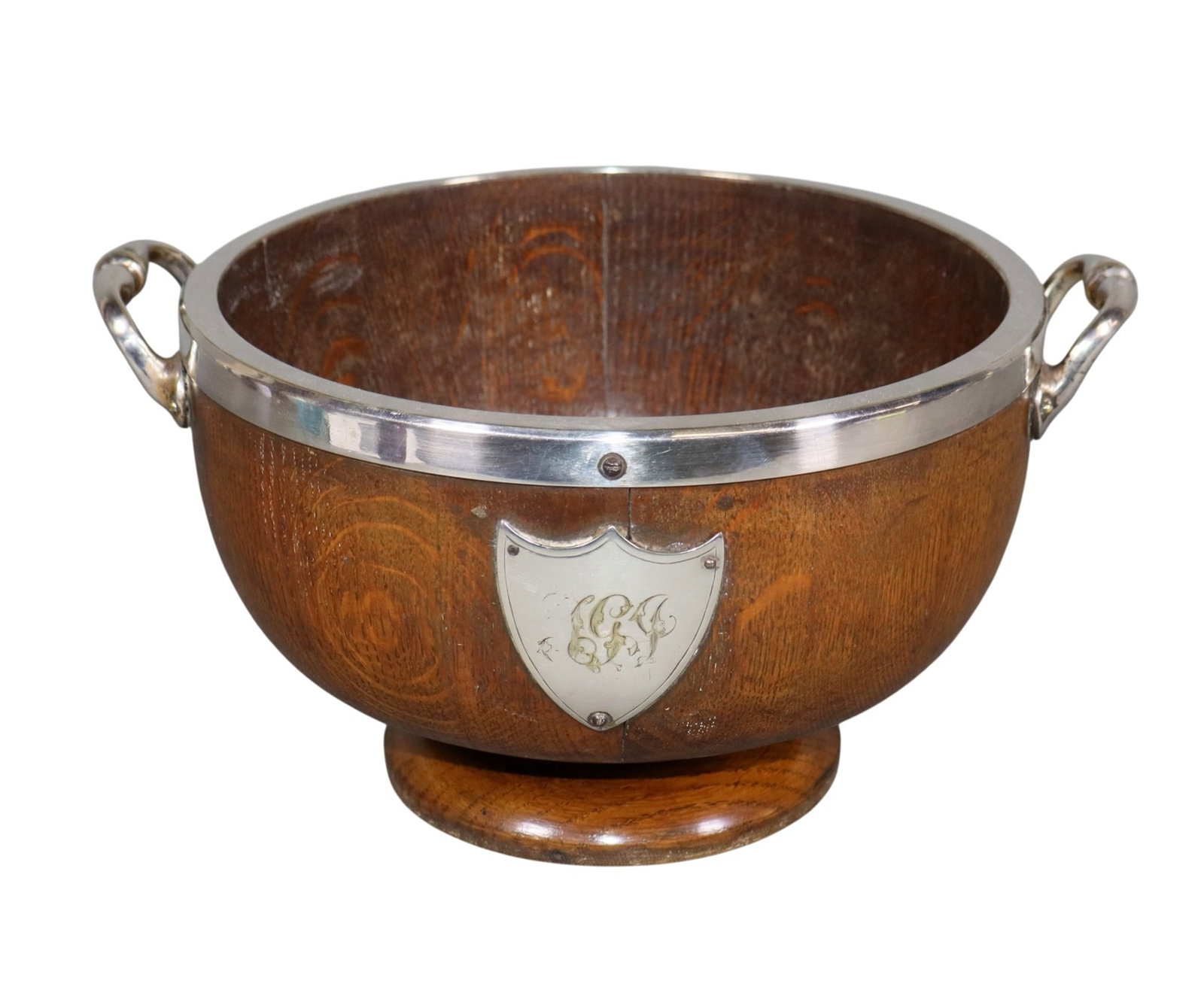 English oak trophy bowl with silverplate handles: English oak trophy bowl with silverplate handles. 5 3/4"h x 11 1/4"w 9 1/4"d. Weight: 3lbs