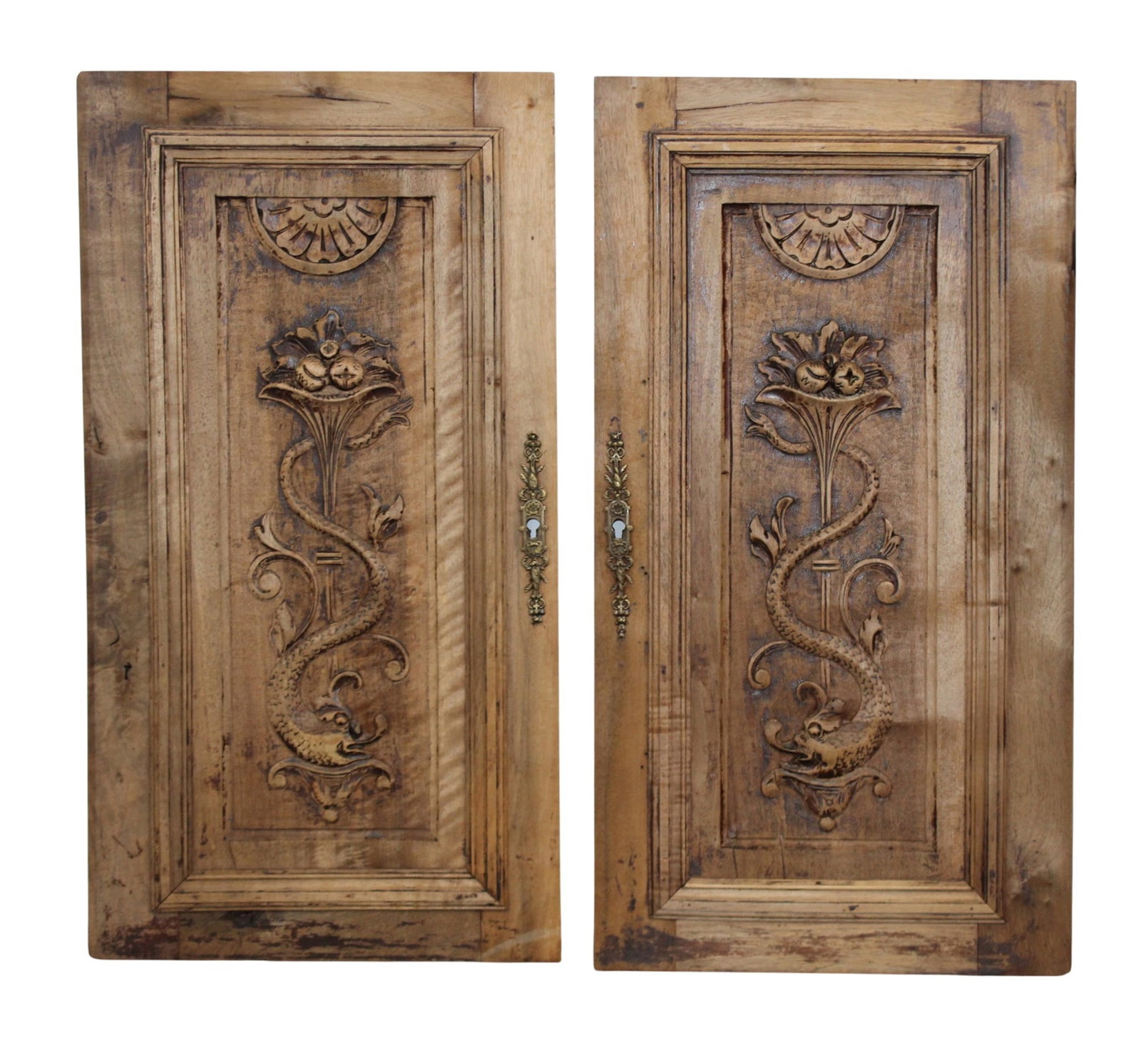 Pair of French cabinet doors as panels with carved fruit and mythological dolphins: Pair of French cabinet doors as panels with carved fruit and mythological dolphins. 26"h x 14"w