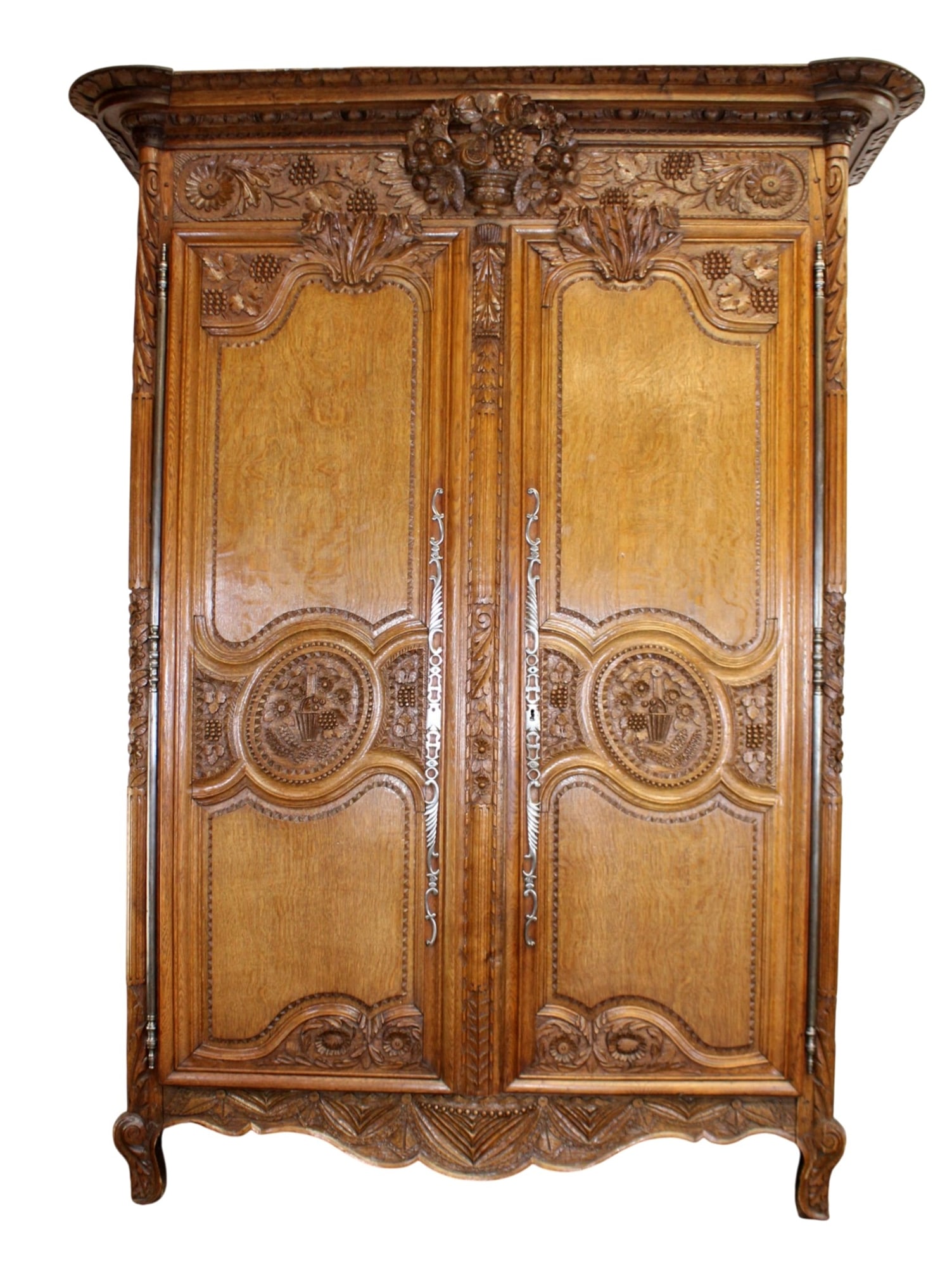 French Normandy armoire in oak with carved flowering urn crest: French Normandy armoire in oak with carved flowering urn crest. 19th century. 93"h x 71"w x 25"d