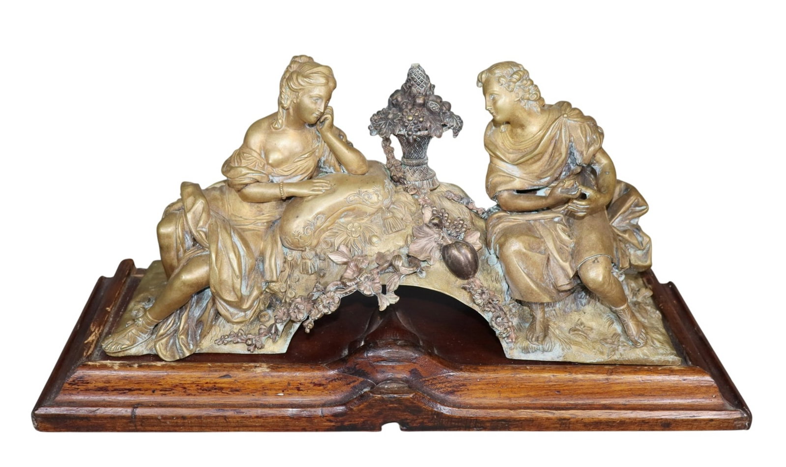 French Neoclassical bronze figural sculpture mounted on carved oak book form plinth: French Neoclassical bronze figural sculpture mounted on carved oak book form plinth. Early 20th century. 9 1/2"h x 19 1/2"w x 6 1/4"d Weight: 19lbs