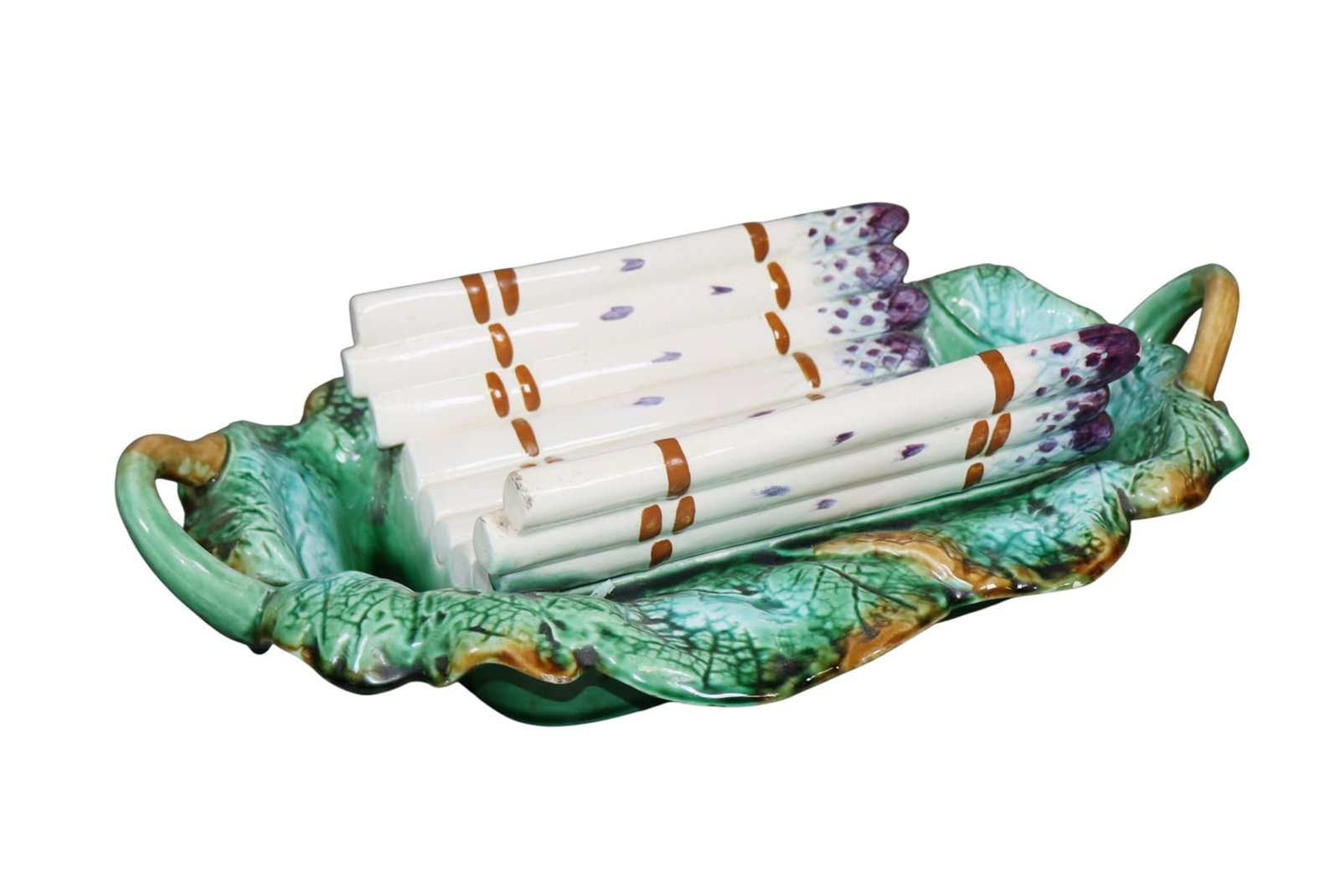 French Barbotine majolica asparagus server: French Barbotine majolica asparagus server with violet tipped asparagus in a leafy platter. Early 20th century. 3 3/4"h x 15 1/4"w x 10"d. Weight: 5lbs