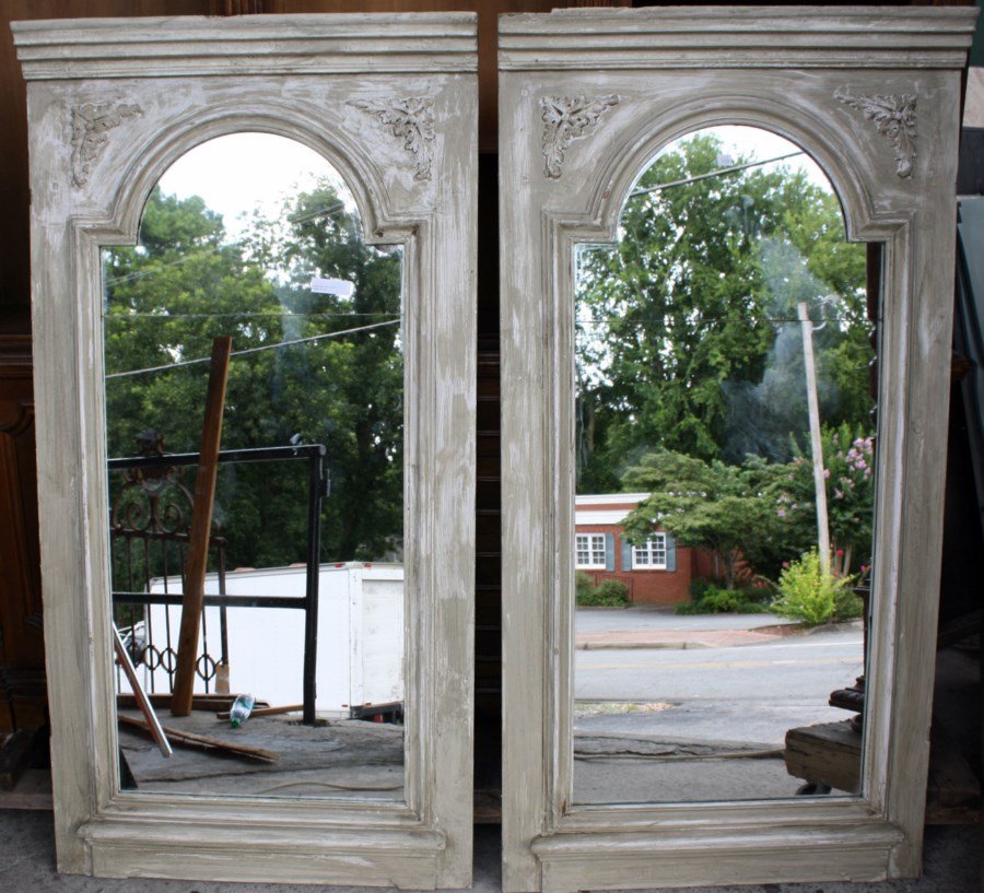 Pair of French weathered trumeau mirrors: Panels are late 19th century from a paneled room. Plaster decoration added later. 64"h x 32 5/8"l