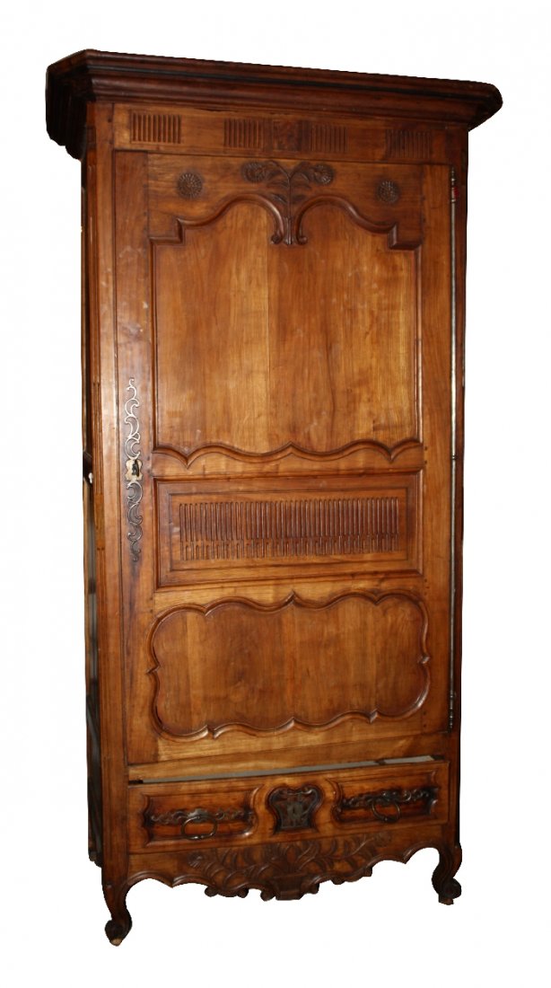 French Provincial bonnetiere in cherry: with long iron hinges and ring pulls on lower drawer. Early 19th century. 91 1/2"h x 47"w x 28"w