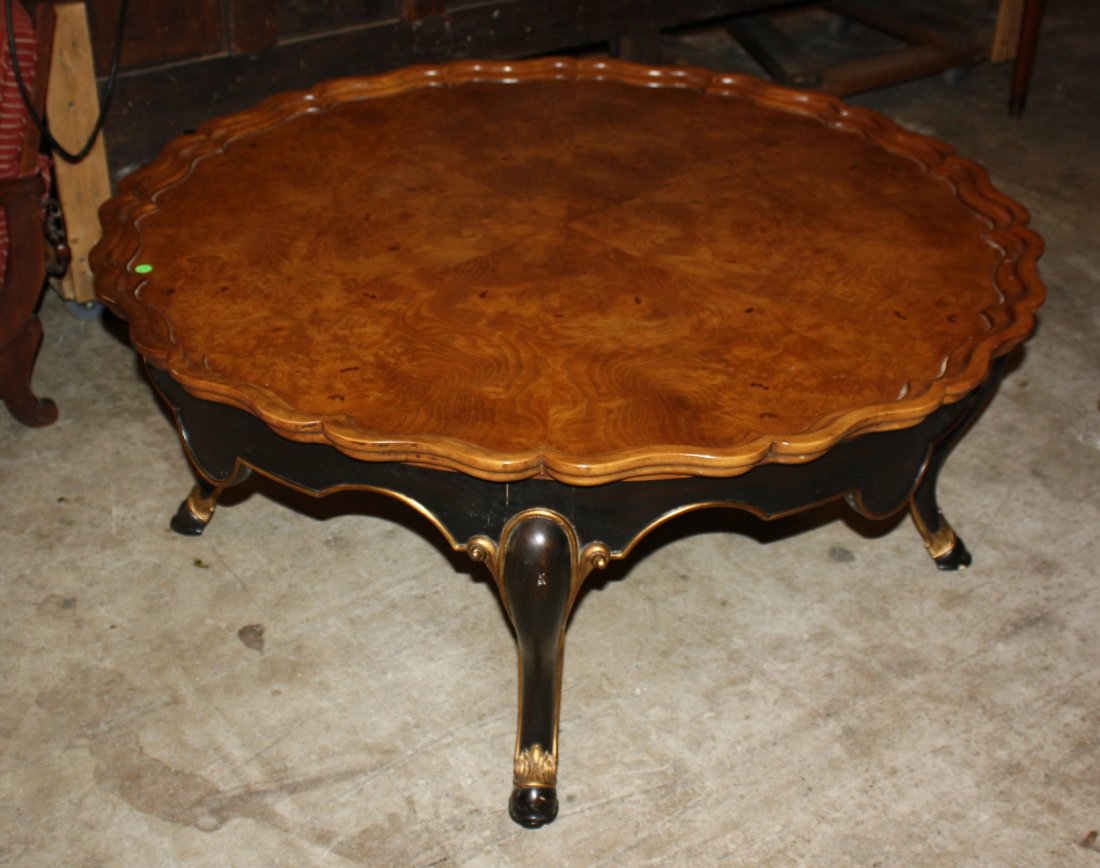 Scalloped edge cocktal table in burled elm: with ebonized base with hoofed feet. 20 1/2"h x 46 1/4"dia
