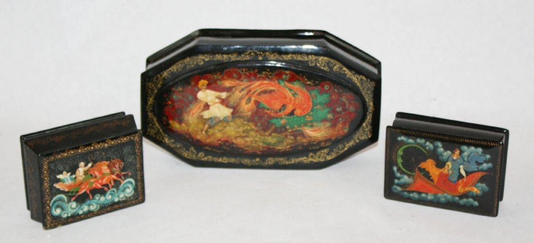 Lot of 3 Russian painted and lacquered boxes artist: signed. Largest box is 1 1/2"h x 7 7/8"l x 4 3/8"d. Box with chariot 1 1/2"h x 3 1/2"l x 2 3/4"d. Box with moon 1 1/4"h x 3 1/4"w