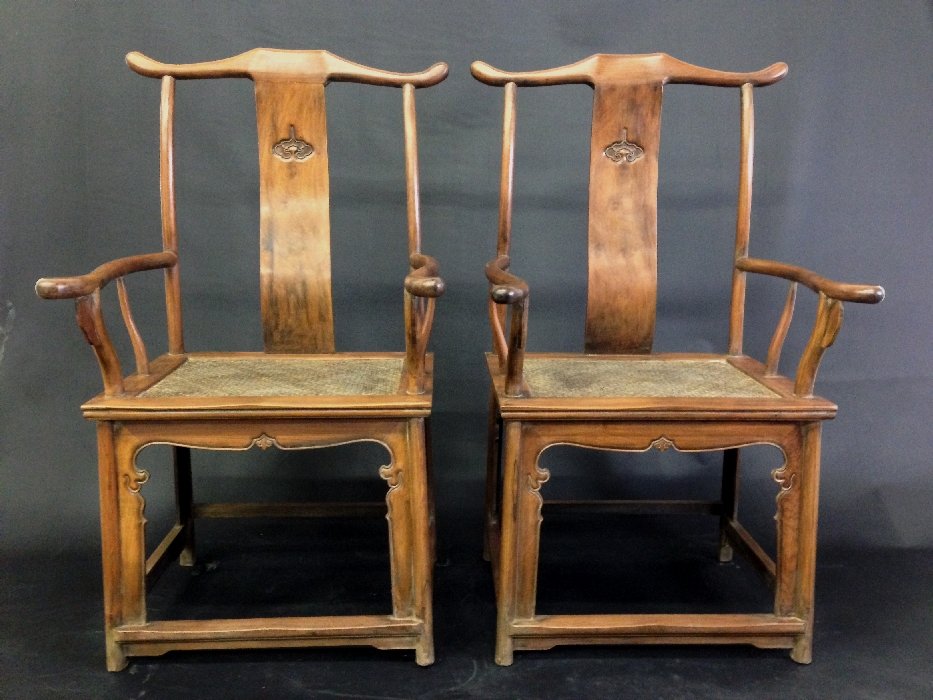 Pair of Chinese HuangHuaLi Arm Chairs,: Pair of Chinese HuangHuaLi Arm Chairs, dense hardwood throughout, HuangHuaLi wood showing fine grain and lustrous patina, each with yoke back, ruyi carved splat, rattan seat, 47 x 24 x 21 in.