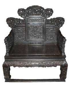 Chinese Zitan large throne Chair with dragons: Chinese Zitan large throne chair. Dense hardwood throughout, with a fine grain, elaborately carved surface- with dragons, foliage, stylized floral scrolling and rococo elements. Five imperial five-toe