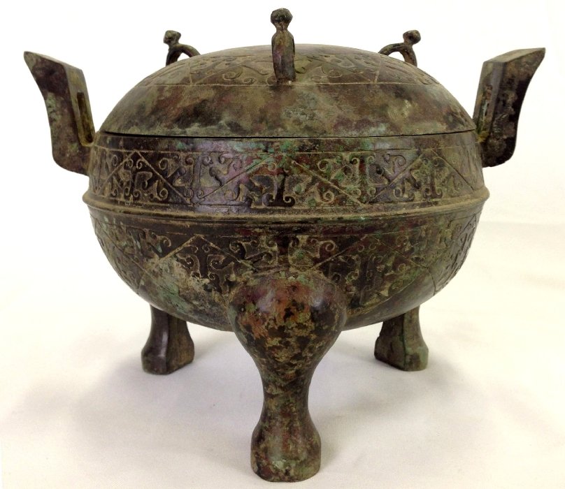Chinese Warring States Covered Bronze Censer: Bronze censer with a domed lid, China, Warring States Period (475-221 BCE). The censer is watermelon shaped and raised on three cabriole supports and is flat-cast on the sides with two bands of differ