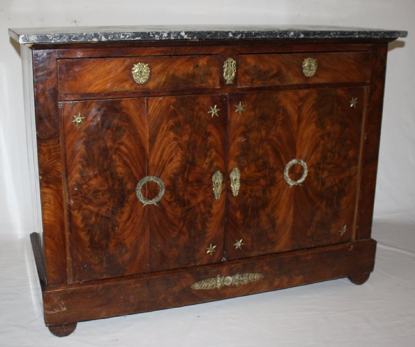 French Empire buffet in flame mahogany: with marble top and gilt bronze accents. Circa 1810. 37 1/2"h x 19 7/8"d x 50 1/2"w