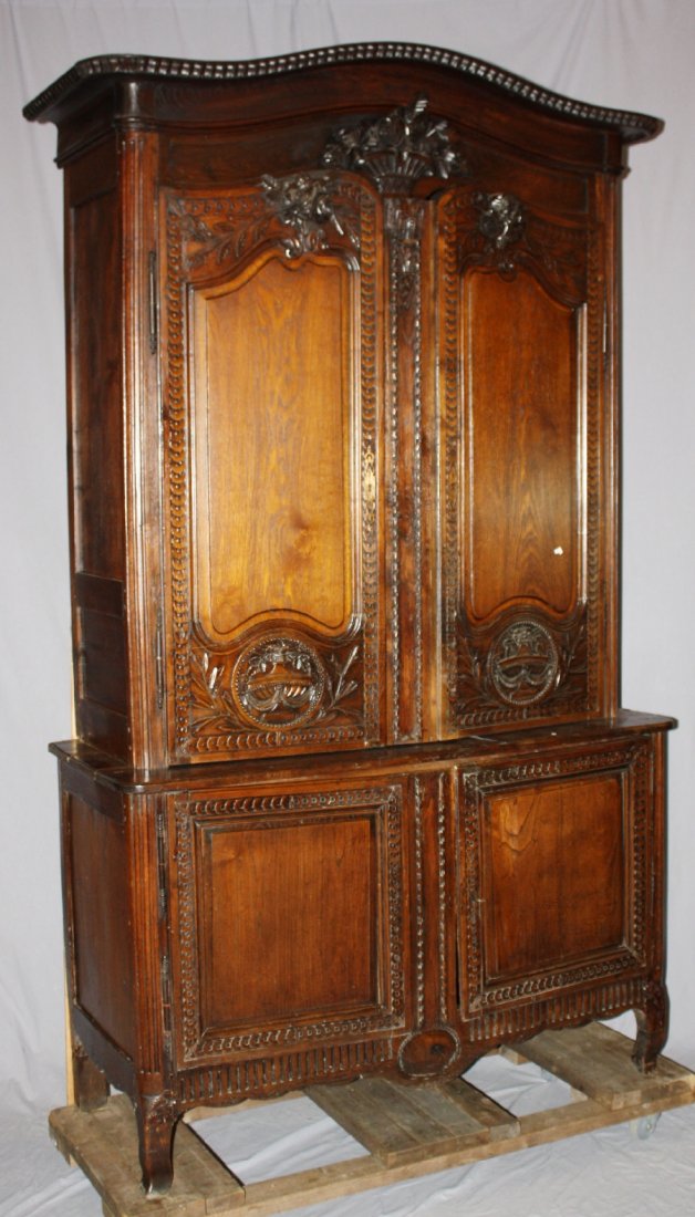 19th century French Provincial buffet deux corps in oak: 19th century French Provincial buffet deux corps in oak with focal pannier basket carving. 97 5/8"h x 57"w x 23"d